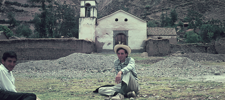 Tim Wallace (center) with a resident of San Miguel, La Mar, in front of a chapel in a highland community, Peru, around 1969. Tim Wallace