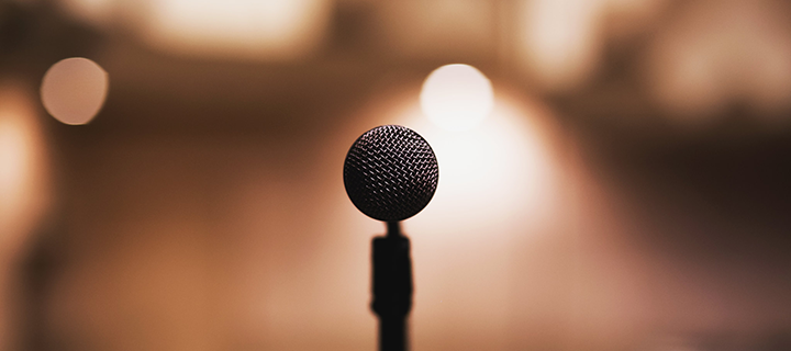Photograph of a microphone in front of a blurred background