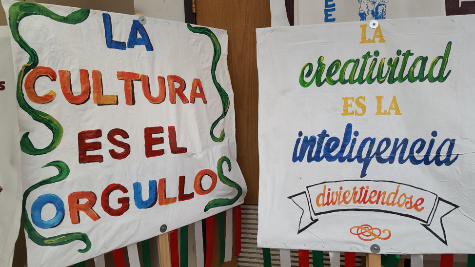 Two student-made signs on display next to each other