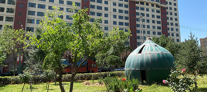 Photograph of a dome on the ground outside of a building
