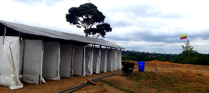 Photograph of temporary showers built in a disarmament camp in Colombia.